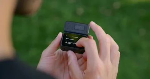 Compact Action Camera In Hand Outdoors With Open Case, Scrolling Menu On Screen Stock Footage 318223439