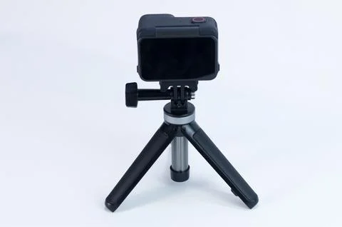 Compact Action Camera on Tripod Against a White Studio Background Stock Photos