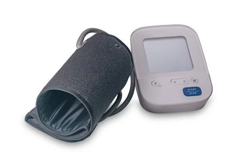 The compact and easy to use digital blood pressure monitor isolated on white. Stock Photos