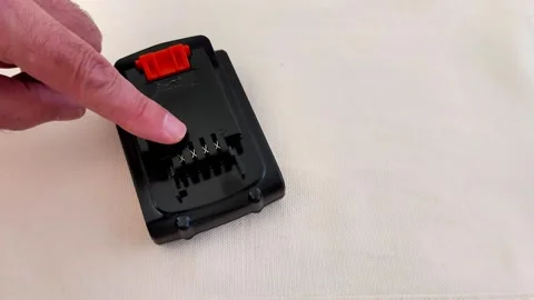 Compact Battery Pack with Metal Connectors and Red Release Clip Stock-Footage 321449982