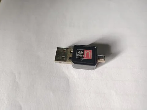 Compact black USB WiFi adapter with an antenna connector and the characteri.. Fotos Stock