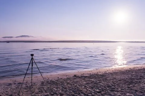 Compact camera on a tripod on the beach Stock Photos