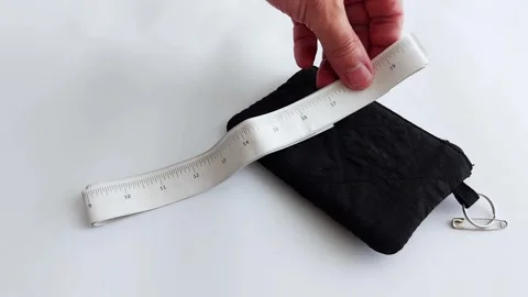 Compact convenience: measuring tape and travel pouch reveal Stock Footage 313117308