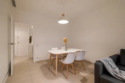 Compact dining zone with a white table and four matching chairs set beside a Stock Photos