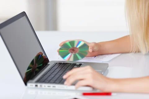 Compact disc and laptop Stock Photos
