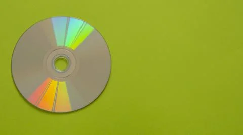 Compact disc on a green colored background 写真素材