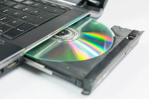 Compact disc inserted in the tray of the SD drive of the notebook on an empty Foto stock