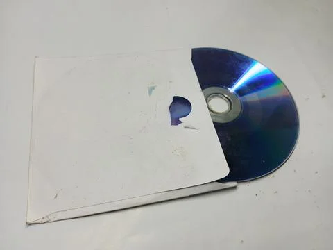 Compact disc inside white paper sleeve on white background Stock Photos