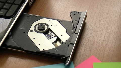 Compact disc in laptop Stock Footage 79851771