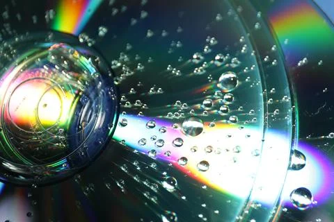 Compact discs with drops as background, closeup Stock Photos