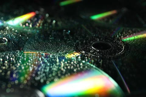 Compact discs with drops as background, closeup Stock Photos