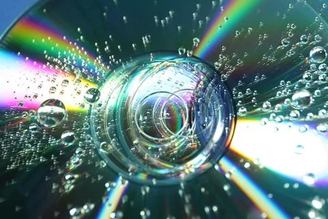 Compact discs with drops as background, closeup Stock Photos
