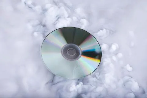 Compact disk in the clouds. Conceptual image. Sound cloud Stock Photos