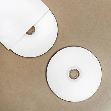 Compact disk Photo of blank compact disk on a table. Template for branding... Stock Photos