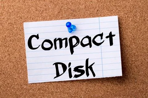 Compact Disk - teared note paper pinned on bulletin board Foto stock