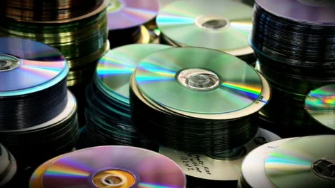 Compact DVD or CD Discs piles standing on table Stock Footage 76636125