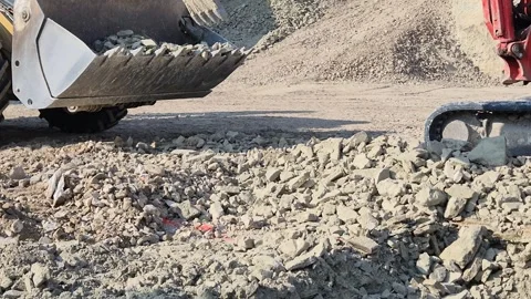 Compact Excavator Digging Hard Soil and Loading Another Machine - 4K Vídeos de archivo 331602478