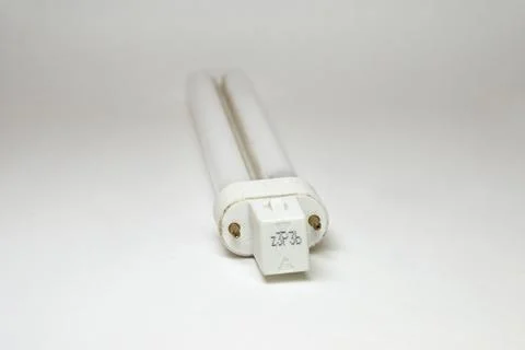 Compact fluorescent lamp, CFL. single tube. 2 pin plug closeup. for table l.. Stock Photos