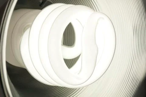 Compact Fluorescent Light Bulb Glowing Stock Photos