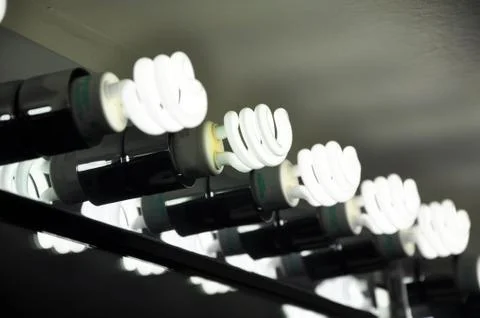 Compact fluorescent lights in vanity mirror Stock Photos