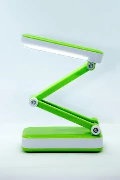 Compact foldable portable LED Desk Lamp with flexible body made of bright gre Stock Photos