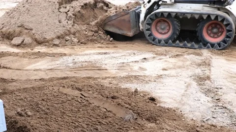 Compact front loader hauls and moves a load of dirt. Stock Footage 154331747