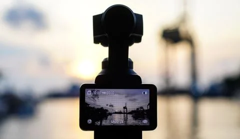 Compact gimbal action camera recording harbor sunset Stock Photos