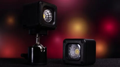 Compact led work lights with adjustable mounts on dark background Stock Footage 345485873