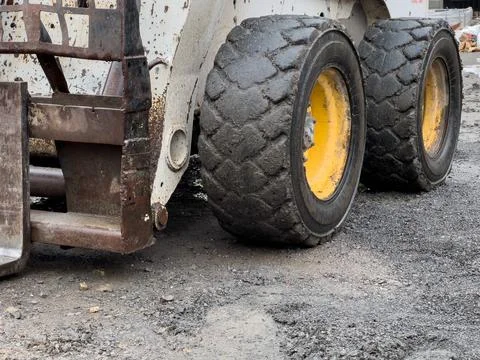 The compact loader is positioned on a gravel surface Foto stock