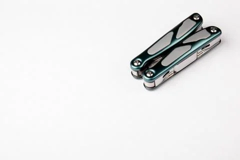 Compact multitool on white background. Tools for cutting, sawing, screwing and Stock Photos