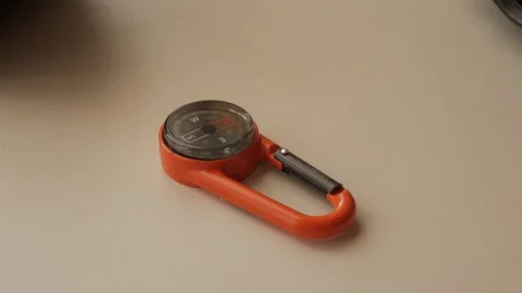 Compact Orange Compass Carabiner for Adventure and Direction Stock Footage 334580058