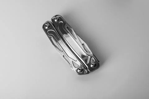Compact portable metallic multitool on white background, top view Stock Photos