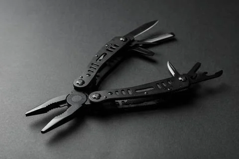 Compact portable multitool on black background, closeup Stock Photos