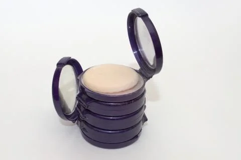 Compact powder boxes in stack, the upper and lower cases with powredpuff is o Stock Photos