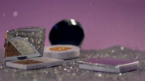 Compact powders with a mirror stand on the surface among the shiny particles. Stock Footage 77512207