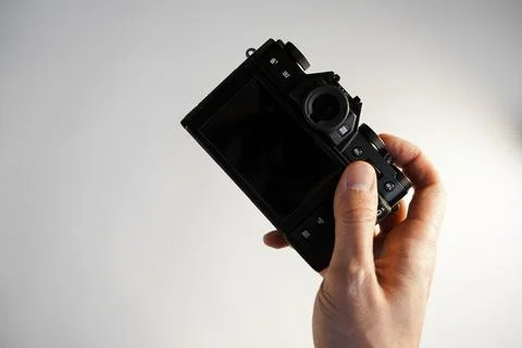 Compact professional mirrorless camera in hand Foto stock