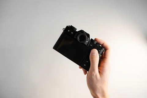 Compact professional mirrorless camera in hand Stock Photos