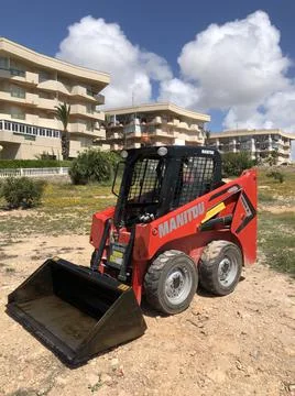 Compact red mini utility loader left outdoor Foto stock