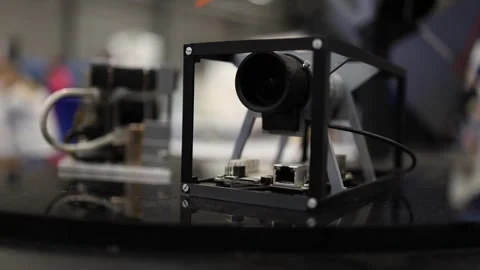 Compact satellite camera module mounted in open cube frame with exposed connecto Stock Footage 311130856