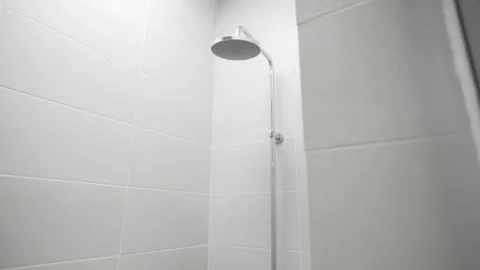 Compact shower features modest fixture with basic spray head Stock Footage 311385854