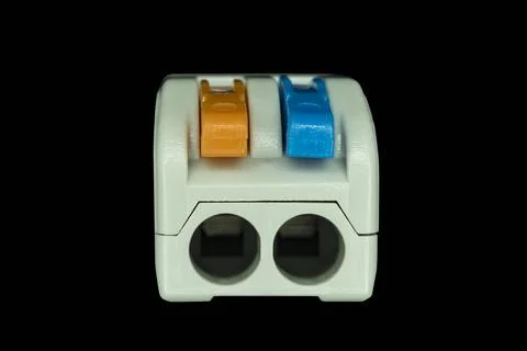 Compact splicing connector isolated on black background. Stock Photos