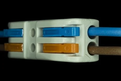 Compact splicing connector isolated on black background. Stock Photos