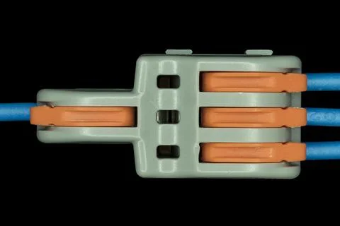 Compact splicing connector isolated on black background. Stock Photos