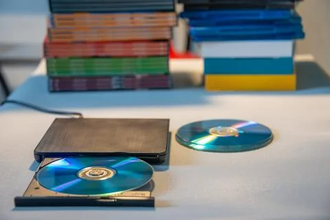 Compact stylish video player for CD and DVD disks with a pile of many TV se.. Stock Photos
