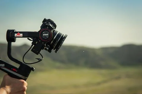 Compact Three-axis stabilizer Zhiyun Weebill S in operator hand outdoor Stock Photos