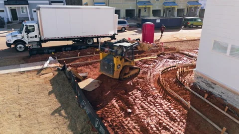 Compact Track Loader Moving Dirt On A Construction Site. - aerialfollow shot Stock Footage 337555287