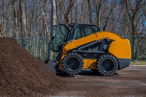 Compact track loader mulch bio woods raw tractor Stock Photos