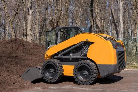 Compact track loader mulch bio woods raw tractor wooden bio brown Stock Photos