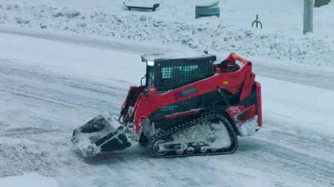 Compact track loader with a snow blade street snow removal Stockbeeldmateriaal 302374373