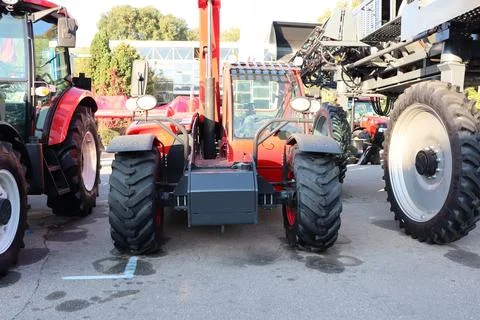 The Compact Tractor equipped with a Loader showcased at the Agricultural Stock Photos